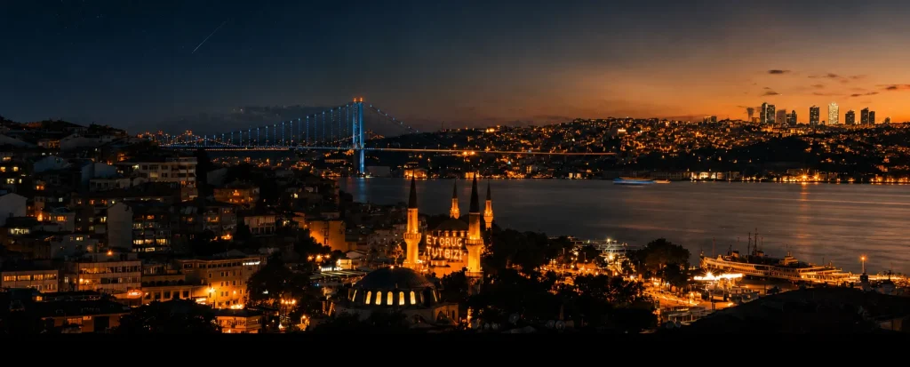 Istanbul skyline at night with city lights reflecting over the Bosphorus after sunset.